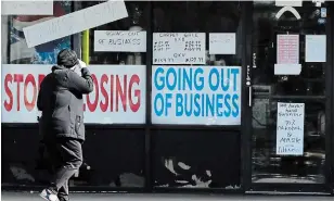  ?? NAM Y. HUH THE ASSOCIATED PRESS FILE PHOTO ?? A woman looks at signs at a store in Niles, Ill., on May 13. The U.S. Labor Department reported 38.6 million jobs have been lost since the COVID-19 pandemic hit the country.