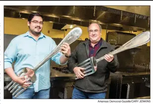  ?? Arkansas Democrat-Gazette/CARY JENKINS ?? Besides being foodies, father and son and co-chairmen of Diamond Chef Arkansas, Frank Cox (right) and F.H. Cox, are both musicians. Says Frank, “I’ve been playing for 50 years. I play with a band called the Groan Ups started in ’83. He [F.H.] took up...