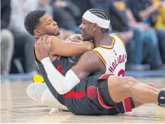  ?? AP ?? The Pacers’ Aaron Holiday, right, and the Raptors’ Kyle Lowry battle for the ball.