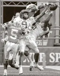  ?? Ricardo B. Brazziell / Associated Press ?? Texas DB Josh Thompson swats the ball out of Iowa State WR Tarique Milton’s hands in the end zone in the second quarter. The Cyclones scored just nine points on three first-half red-zone trips.