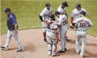  ?? AP PHOTO ?? CHANGE IT UP: Red Sox manager John Farrell heads back to the dugout after putting reliever Joe Kelly in the game.