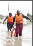  ?? ?? Kenyan Red Cross personnel and volunteers conduct search and rescue missions, around houses submerged by flood water in Machakos county, Kenya on April 22. Flooding and heavy rains in Kenya have killed at least 70 people since mid-March, a government spokespers­on said Friday, twice as many as were reported earlier this week. (AP)