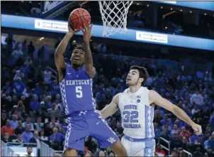  ?? The Associated Press ?? SCORING IN STYLE: Kentucky’s Malik Monk (5) shoots in front of North Carolina’s Luke Maye (32) during an NCAA college basketball game on Dec. 17, 2016, in Las Vegas. The former Bentonvill­e star scored 47 points in the win over the Tar Heels, the most...