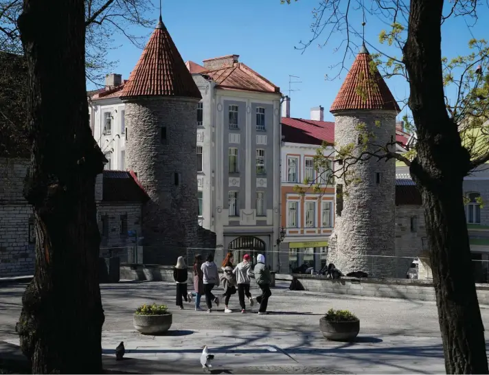  ?? ?? Young people pose for a selfie in the Old Town during a sunny day in Tallinn, Estonia, Monday, May 16, 2022. Photo: AP