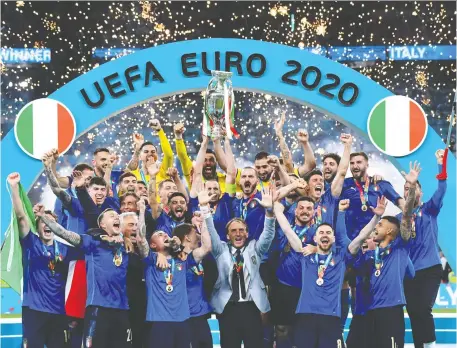  ?? CLAUDIO VILLA/GETTY IMAGES ?? The Italian men's soccer team celebrates after winning the UEFA Euro 2020 championsh­ip against England at Wembley Stadium on Sunday. It was Italy's first major tournament win since 2006 and first European championsh­ip since 1968.