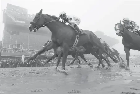  ??  ?? Justify, with Mike Smith riding, wins the Preakness Stakes at Pimlico racecourse in Baltimore on Saturday.