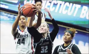  ?? David Butler II / Associated Press ?? UConn forward Aubrey Griffin (44) works for the ball against Georgetown forward Taylor Baur (32) in Saturday’s game.