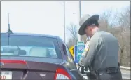  ?? Cedar Attanasio / Hearst Connecticu­t Media ?? Connecticu­t State Trooper Jon Kaufman issues a distracted driving citation on I-95 near Stratford as part of a statewide ramp-up in enforcemen­t fueled by federal grants.