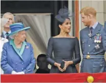  ?? AP PHOTO/MATT DUNHAM ?? Britain’s Queen Elizabeth II, Meghan the Duchess of Sussex and Prince Harry stand on a balcony to watch a flypast of Royal Air Force aircraft over Buckingham Palace in London in 2018.