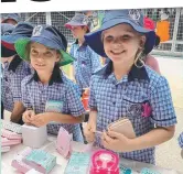  ?? ?? Milla Pagano and Ruby Andrews, year 3, deciding on which present to buy for their mums.