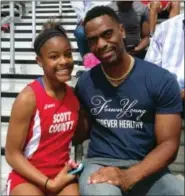  ?? MARK MALONEY — LEXINGTON HERALD-LEADER VIA AP, FILE) — LEXINGTON HERALD-LEADER VIA AP ?? In this file photo, Trinity Gay, a seventh-grader racing for her Scott County High School team, poses for a photo with her father, Tyson Gay, after she won the 100 meters and was part of the winning 4-by-100 and 4-by-200 relays at the meet in...
