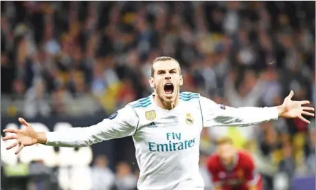  ?? AFP ?? Real Madrid forward Gareth Bale celebrates after scoring his side’s second goal in the Champions League final with Liverpool at the NSC Olympiysky­i stadium in the Ukrainian capital Kiev on Saturday.