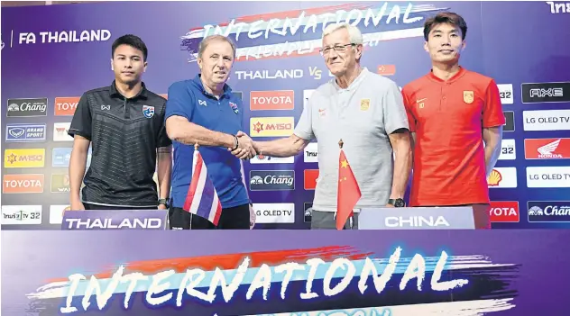  ??  ?? Thailand coach Milovan Rajevac, left, shakes hands with China boss Marcello Lippi at yesterday’s press conference ahead of today’s friendly match.