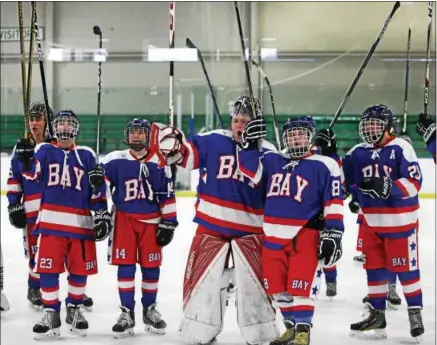  ?? RANDY MEYERS - ?? Bay players salute Rockets fans after defeating Olmsted Falls on Feb. 19 at Brooklyn.