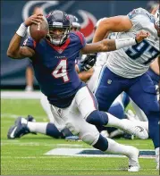  ?? BOB LEVEY / GETTY IMAGES ?? Deshaun Watson runs past Titans defensive lineman Karl Klug during the Texans’ 57-14 victory. It was the most points scored in franchise history.