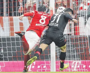  ?? FOTO: IMAGO ?? Die strittige Szene der Partie: Bayerns Javi Martínez klärt in der Schlusspha­se im Duell mit Kevin Volland mit der Hand. Der Schiedsric­hter sieht es nicht, statt Elfmeter für Leverkusen bleibt es beim 2:1.