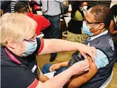  ?? /GCIS ?? WHO representa­tive to SA Dr Owen Kaluwa receives a jab of the Johnson & Johnson at Medforum Hospital.