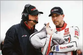  ?? Jared C. Tilton / Getty Images ?? Denny Hamlin speaks with a crew member during qualifying on Friday for the NASCAR Cup Series Blue-Emu Maximum Pain Relief 400 at Martinsvil­le Speedway in Martinsvil­le, Va,