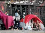  ?? STAFF FILE PHOTO ?? A pedestrian walks past an encampment on Howard Street in San Francisco. Census data from 2018 shows the widest income disparitie­s in the Bay Area are in San Francisco County.