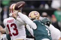  ?? SETH WENIG — THE ASSOCIATED PRESS ?? Philadelph­ia Eagles linebacker Haason Reddick, right, causes a fumble by San Francisco 49ers quarterbac­k Brock Purdy during the first half of the NFC Championsh­ip game on Sunday, in Philadelph­ia.