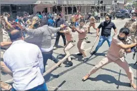  ?? ANI ?? Police personnel wield batons as a clash breaks out between Shiv Sena and BJP supporters during a protest march towards Union minister Narayan Rane's residence in Mumbai on Tuesday.