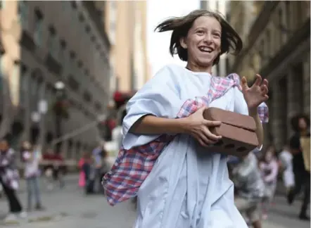  ?? RICHARD LAUTENS/TORONTO STAR ?? Sick Kids patient-turned-actor Jayden Liuzza runs through downtown streets during a Sick Kids video shoot last month. The video is being released today to launch the hospital’s campaign to rebuild aging facilities.