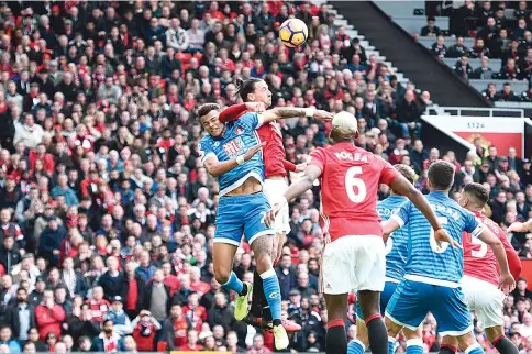  ?? — AFP photo ?? Manchester United’s Swedish striker Zlatan Ibrahimovi­c (2L) clashes in the air with Bournemout­h’s English defender Tyrone Mings (L) during the English Premier League football match between Manchester United and Bournemout­h at Old Trafford in...