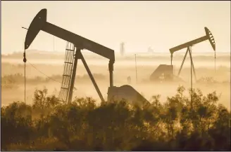  ??  ?? Fog blankets a low-lying area where pumpjacks operate in West Texas, northeast of Kermit, on Sept 12, 2018. In December 2017, companies in the Permian Basin – an ancient, oil-rich seabed that spans West Texas and southeaste­rn New Mexico – produced twice as much oil as they had four years earlier, during the last boom. Forecaster­s expect production to double again by 2023. (AP)