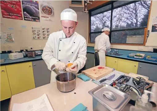  ?? Photo: NICOLE JOHNSTONE/FAIRFAX NZ 630954504 ?? Spencer McIntosh, left, 17, and Mitchell Leask, 18, prepare for the National Secondary School Culinary Challenge tomorrow.