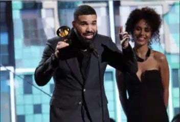  ?? PHOTOS BY MATT SAYLES — INVISION — AP ?? Drake accepts the award for best rap song for “God’s Plan” at the 61st annual Grammy Awards on Sunday in Los Angeles.