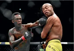  ??  ?? Israel Adesanya, left, had a jibe at Robert Whittaker following his victory over Anderson Silva in Melbourne. GETTY IMAGES
