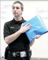  ?? LYNN KUTTER
ENTERPRISE-LEADER ?? Washington County Deputy Coroner Cory Whorton explains about the different body bags used by the coroner’s office. A blue bag is used for an average body; yellow is used for larger bodies and infants are placed in white bags. Whorton addressed eighth...