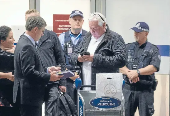  ?? Photo: FAIRFAX ?? Concert promoter Andrew McManus is arrested by police at Melbourne Airport on charges of perverting the course of justice, attempting to defraud by false of misleading statements and knowingly participat­ing in a criminal group to assist crime.