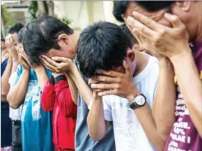  ?? JUNI KRISWANTO/AFP ?? Indonesian police parade a group of men, arrested for allegedly holding a ‘gay party’, in Surabaya, the second biggest city in Indonesia, on April 30.