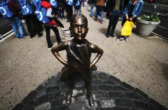  ?? JEWEL SAMAD/AFP/GETTY IMAGES ?? Wall Street’s Fearless Girl statue was a controvers­ial figure this year, with some lauding the statue, while others dismissed it as a marketing ploy for State Street Global Advisors.