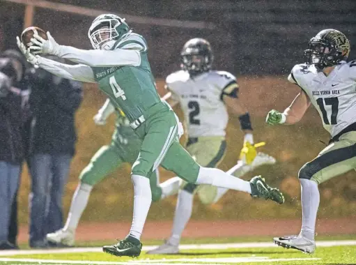  ?? Steph Chambers/Post-Gazette ?? South Fayette’s Mike Trimbur catches a pass in front of Belle Vernon’s Hunter Ruokonen in the WPIAL Class 4A semifinals Friday night at Joe Montana Stadium in Monongahel­a.