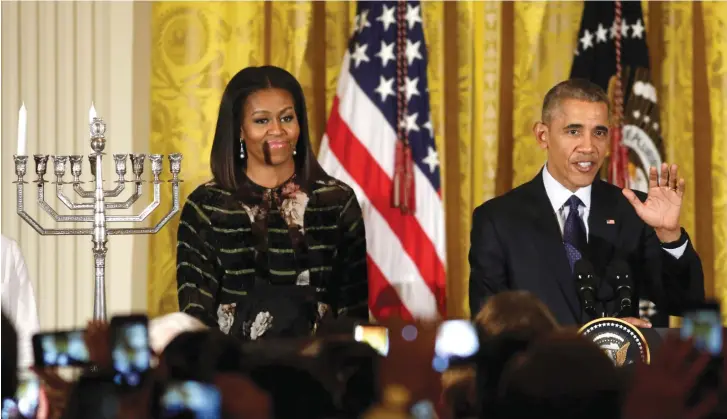  ??  ?? THEN-US PRESIDENT Barack Obama speaks next to former first lady Michelle Obama at a Hanukka reception at the White House in Washington, last month.