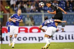  ?? — AFP photo ?? AC Milan's Colombian forward Carlos Bacca (R) heads the ball during the Italian Serie A football match Sampdoria vs AC Milan on September 16, 2016 at the Luigi Ferraris Stadium in Genoa.