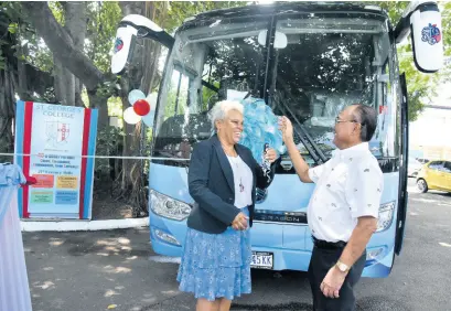  ?? KENYON HEMANS/PHOTOGRAPH­ER ?? St George’s College principal Margaret Campbell, is overjoyed after receiving the keys to two new buses valued at more than $25 million from Phillip Wong, a member of the St George’s College Old Boys Associatio­n on Thursday, September 22. The buses were handed over to the principal during a small ceremony held on the school grounds.