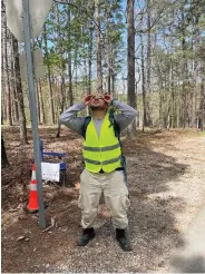  ?? (Submitted photo courtesy of Arkansas State Parks) ?? An AmeriCorps volunteer takes a moment to look at the eclipse at Lake Ouachita State Park Monday.