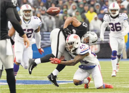  ?? Adrian Kraus / Associated Press ?? DeAndre Washington, hit by the Bills’ Leonard Johnson, fumbles the football. It was returned by Matt Milano for a TD.