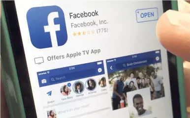  ?? AP ?? In this file photo, a user gets ready to launch Facebook on an iPhone, in North Andover, Massachuse­tts. Facebook and record label Universal Music Group have signed a multi-year deal that will let Facebook users share videos that have the label’s music...