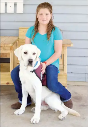  ?? MATT JOHNSON/CONTRIBUTI­NG PHOTOGRAPH­ER ?? A Type 1 diabetic Sunnie Simpson, 10, bonds with her new diabetic-alert dog, Bentley, whom she recieved recently after a $25,000 fundraisin­g campaign conducted by her mother. Bentley smells the difference­s in Sunnie’s blood-sugar levels and taps either...