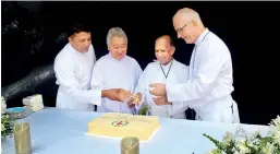  ??  ?? From left to right: : Fr. Shiran, Fr. Ben, Fr. Neil and Fr, General cutting the anniversar­y cake