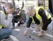  ??  ?? CHRISTOPHE­R NOLAN, right, uses toy cars to block out the car chase with crew members on set.