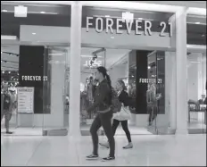  ?? ASSOCIATED PRESS ?? In a September 30, 2019 file photo, people walk in front of a Forever 21 clothing store in New York.