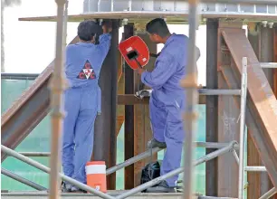  ?? Photo by M. Sajjad ?? workers ensure safety at a constructi­on site at Al Soor area in Sharjah —