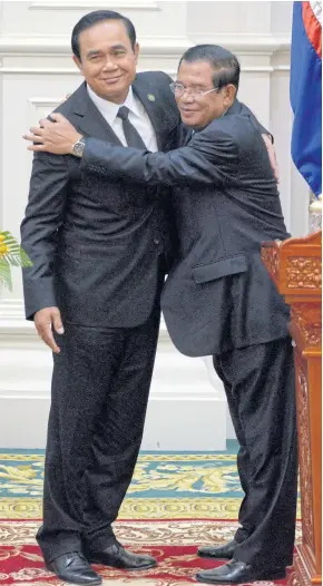  ?? AFP ?? Cambodian Prime Minister Hun Sen, right, hugs Prime Minister Prayut Chan-o-cha at the Peace Palace in Phnom Penh yesterday.