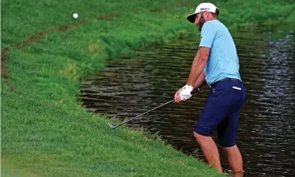  ?? Photograph: Bill Streicher/USA Today Sports ?? Dustin Johnson narrowly avoided disaster on the 15th, when he had to play his shot standing in a pond.