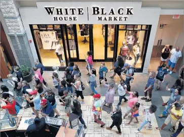  ?? Jeff Roberson Associated Press ?? SEVERAL HUNDRED demonstrat­ors marched through West County Center mall in a peaceful protest.